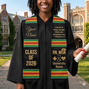 May include: Black graduation sash with gold text reading "Your Name" and "Class of 2026." The sash has green, yellow, and red stripes. The other side reads "RN, MSN" and "University Name" with a cross, stethoscope, and heart symbol.