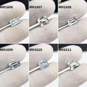 Pode incluir: Uma coleção de seis pedras preciosas de corte retangular em tons de azul e verde. Cada gema é segurada por uma mão enluvada, com os códigos do produto MH1606, MH1607, MH1608, MH1609, MH1610 e MH1611 visíveis.