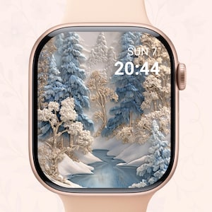 May include: A rose gold smartwatch with a winter forest scene on the screen. The screen displays a snowy landscape with blue and white trees, a river, and the time: SUN 7 20:44.