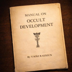 May include: A well-worn book, "Manual on Occult Development" by Yacki Raizizun. The cover is a faded beige with black lettering and a decorative emblem. The book shows signs of age, with visible wear and tear.
