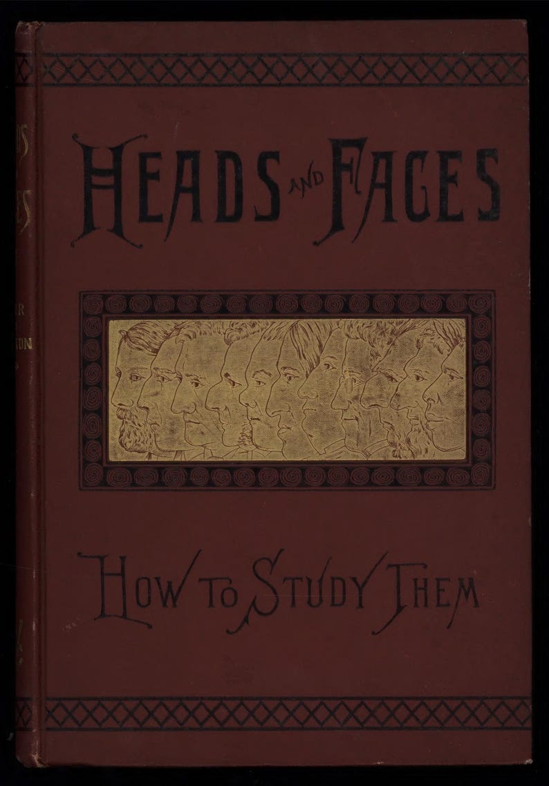 May include: A vintage book cover with the title "Heads and Faces" and the subtitle "How to Study Them" in ornate black lettering. The cover is a deep red with a gold-toned illustration of several profile portraits.
