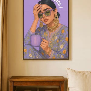 May include: A framed art print featuring a woman in a blue floral patterned outfit, holding a purple mug. She wears sunglasses and gold jewelry. The text "SIRR NA KHAA!" is above her head.