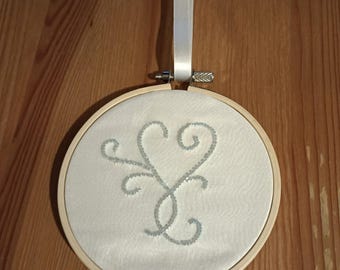 Hand beaded hanging decoration on silk in bamboo hoop