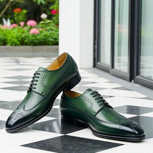 May include: A pair of green leather dress shoes with black laces. The shoes have a wingtip design with decorative perforations and a glossy finish. The shoes are displayed on a black and white checkered floor.