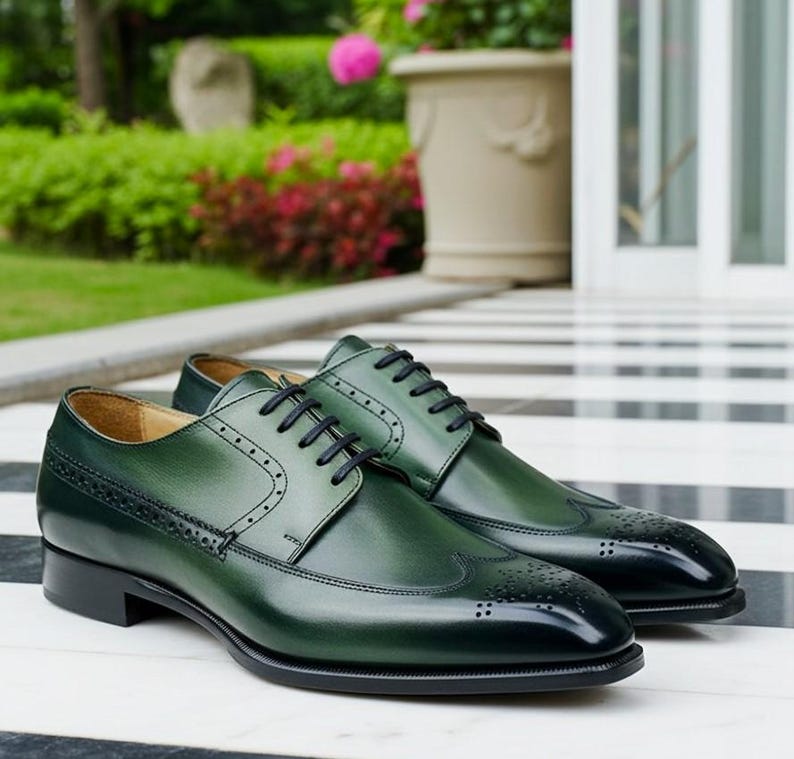 May include: A pair of green leather dress shoes with black laces. The shoes have a classic wingtip design with decorative perforations and a glossy finish. The soles and heels are black.