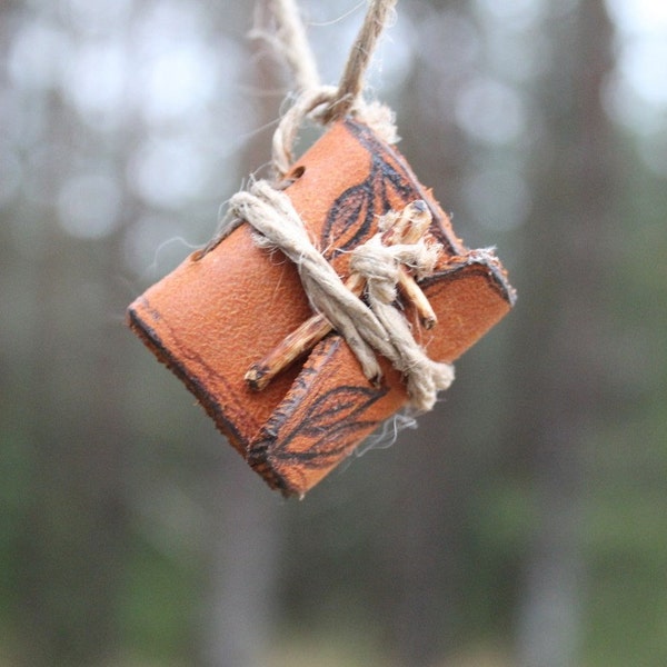 Little book necklace closed with natural wood branch and jute cord