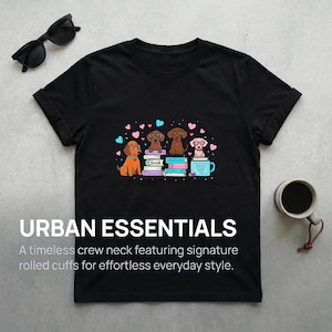May include: Black crew neck t-shirt with a graphic of four dogs wearing glasses, sitting on books, and a coffee mug. The text "URBAN ESSENTIALS" and a description are printed on the shirt.