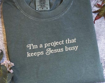 I'm A Project that Keeps Jesus Busy Shirt, Funny Christian Comfort Colors® , Humor Faith Gift for Her, Sarcastic Religious Mama Top