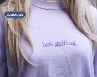 Comfort Colors® He's Golfing Shirt, Golfing Season Shirt, Golfer Wife Shirt, Golfing Mom Shirt, Golf Player Shirt for Mom, Golf Lover Shirt