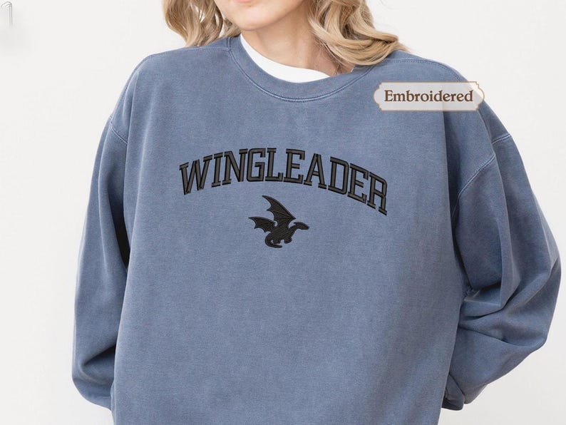 A person wearing a blue sweatshirt with the text "WINGLEADER" printed on it.