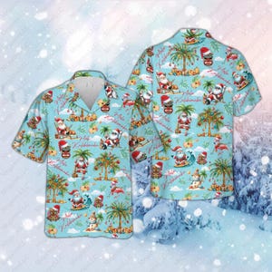 May include: Light blue Hawaiian shirt featuring a festive Christmas-themed design. The shirt showcases Santa Claus, palm trees, and tropical elements. The phrase "Aloha Kolikinaka" is printed on the shirt. The shirt is short-sleeved.