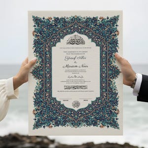 May include: A decorative wedding certificate with ornate teal and blue floral border. The document features Arabic calligraphy and the names "Yusif Alvi & Mariam Noor". The certificate is held by two people against a backdrop of the ocean.