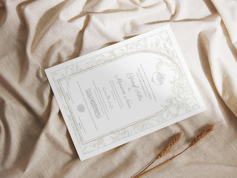May include: A formal invitation with floral and ornate border details. The invitation features the names Yusuf Ali and Mariam Noor in elegant script. The background is a neutral beige fabric, with two stalks of wheat in the foreground.