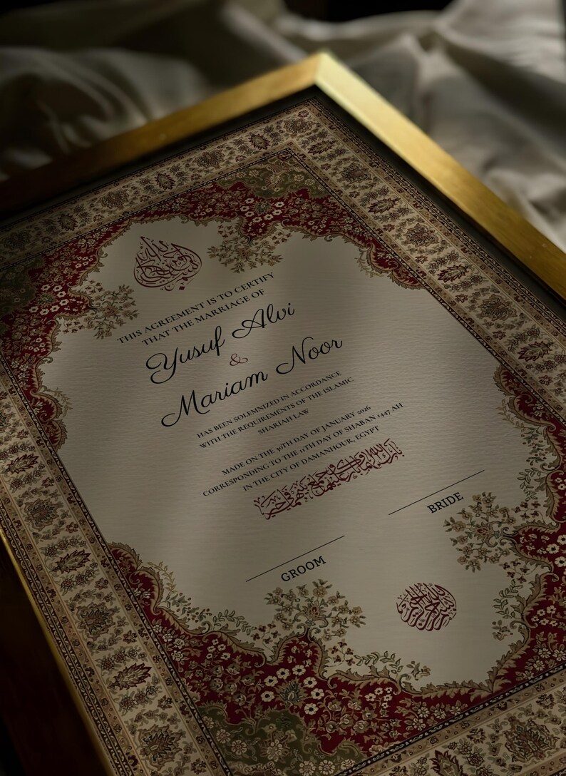 May include: A framed marriage certificate with an elaborate border design. The document, in English, certifies the marriage of Yusuf Alvi and Mariam Noor, with details of the date and location in Egypt. The frame is gold.