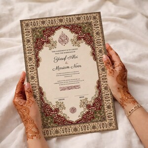 May include: A wedding certificate with a decorative border in burgundy, green, and gold, held by hands with henna tattoos. The text reads "Yusuf Alvi & Mariam Noor".
