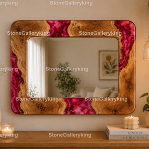 May include: A rectangular wall mirror featuring a natural wood frame with vibrant magenta resin inlays. The wood grain is visible throughout the frame, contrasting with the smooth, translucent pink resin sections. The mirror reflects a room interior.