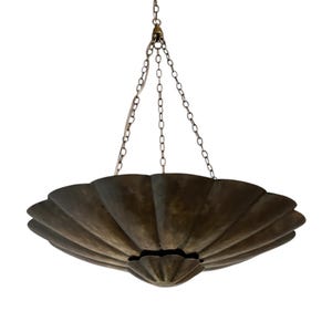 May include: A bronze-colored, scalloped-edge chandelier suspended from chains. The fixture has a layered, fan-like design with a central, rounded base. The chains and hardware are a matching bronze tone, creating a cohesive, elegant lighting element.