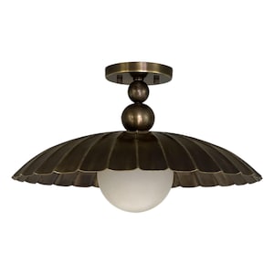 May include: A bronze-colored ceiling light fixture with a scalloped shade and a frosted glass globe. The fixture has a round base and a decorative stem with two spheres. The shade has a fan-like design.