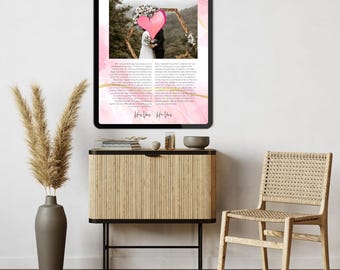 May include: A framed wedding print with a pink and gold watercolor design. The print features a photo of a couple under a floral arch, a pink heart, and the text "His Her was 18.08.2023". The print is displayed on a black tablet.