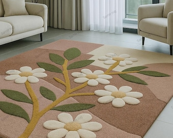 May include: A rectangular area rug with a floral design. The rug features a pattern of white daisies with yellow centers and green leaves on a brown and pink background. The rug is placed in a living room setting.