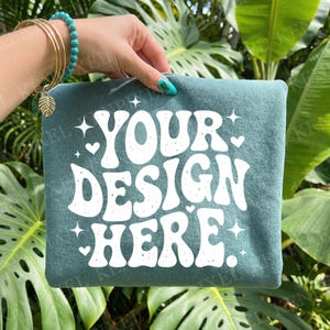 Comfort Colors 1717 Sage Green Shirt Mockup, Hand Held Folded Tee, Tropical Leaf Background, Blank T Shirt Photo