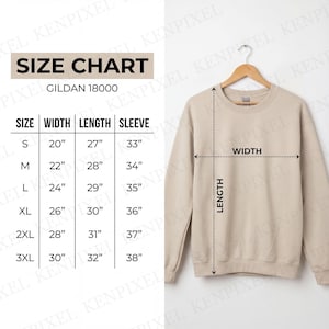 May include: A beige Gildan 18000 sweatshirt hangs on a wooden hanger. A size chart shows measurements in inches for width, length, and sleeve length, ranging from size small to 3XL. The chart includes measurements such as 20" width, 27" length, and 33" sleeve for size small.