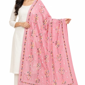 May include: A light pink dupatta featuring intricate embroidery with small circular mirrors and colourful thread work in red, yellow, and black. The fabric has a textured appearance with a decorative border pattern and scattered mirror embellishments.