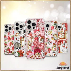 May include: Five phone cases with various designs. Each case has a pink backdrop with illustrations of strawberries, cats, and desserts. The cases have a clear, glossy finish and are designed for a smartphone.