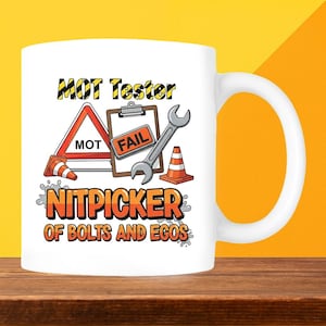 May include: White ceramic mug with a humorous design. The mug features the text "MOT Tester Nitpicker of Bolts and Egos" along with illustrations of a wrench, traffic cones, and a clipboard with "FAIL" on it.