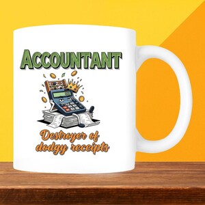 May include: White ceramic mug with a humorous design for accountants. The mug features the word "ACCOUNTANT" in green letters above an illustration of a calculator wearing a crown and sitting on a stack of papers. The text "Destroyer of dodgy receipts" is below the illustration.