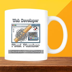 May include: White ceramic mug with a humorous design for web developers. The design features a computer screen graphic with the words "Web Developer" and "Pixel Plumber". The phrase "Internet Duct Tape" is also included.