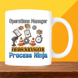 May include: White ceramic mug with the words "Operations Manager," "Chaos Wrangler," and "Process Ninja" printed on it. The mug features cartoon graphics of boxes, gears, cones, and a stopwatch. The mug has a white handle and is set against a yellow background.