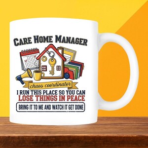 May include: White ceramic mug with a handle, featuring the text "CARE HOME MANAGER" above a graphic of a house, calendar, and other office supplies. Below the graphic, it reads "chaos coordinator" and a humorous quote about losing things.