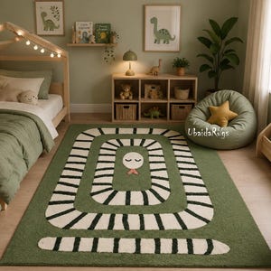 May include: A green rug with a white and black snake design in a child's bedroom. The rug features a snake head with a pink tongue. The room includes a wooden bed, a beanbag chair, and dinosaur artwork.