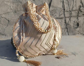 Handcrafted Beige Silk Potli Bag: Pearl Handle Embroidered Clutch