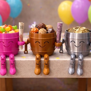 May include: A white ceramic mug with a black handle and the text "But first, coffee" in a black, handwritten-style font. The mug is on a white surface.