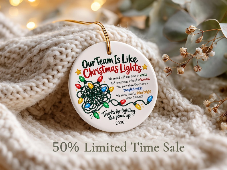 May include: A round white ceramic ornament featuring a colourful illustration of tangled Christmas lights and the text: Our Team Is Like Christmas Lights, We spend half our time in knots, And sometimes a few of us burn out, But even when things are a tangled mess, We know how to shine bright when it counts, Thanks for lighting the place up! - 2026 -
