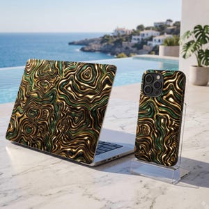 May include: A laptop and a smartphone case featuring a metallic gold and dark green liquid marble pattern with swirling, wavy lines. The laptop is open, and the smartphone case is displayed upright on a clear acrylic stand.