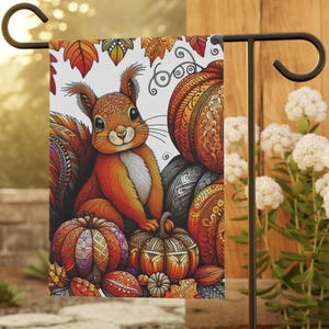 May include: A rectangular garden flag featuring a central illustration of a squirrel surrounded by patterned pumpkins and autumn leaves. The design uses vibrant orange, red, and earthy tones with intricate decorative line work throughout the artwork.