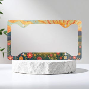 Marco metálico para matrícula con diseño floral de pradera al atardecer - Decoración para coche