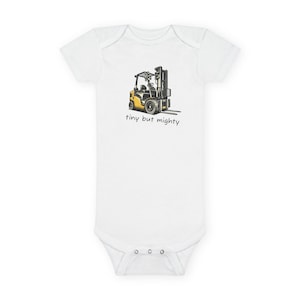May include: White baby bodysuit with a graphic of a yellow and black forklift. The text "tiny but mighty" is printed below the forklift. The bodysuit has short sleeves and snaps at the bottom.