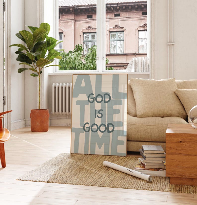 Pu&ograve; includere: Una stampa da parete rettangolare incorniciata con uno sfondo beige chiaro e grandi lettere a blocchi blu tenue che compongono la frase ALL THE TIME, con un testo pi&ugrave; piccolo in grigio scuro centrato che recita GOD IS GOOD.