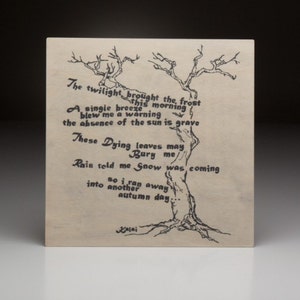 May include: A black and white drawing of a bare tree with a poem about the arrival of frost and snow. The poem reads: "The twilight brought the frost this morning. A single breeze blew me a warning. The absence of the sun is grave. These Dying leaves may Bury me. Rain told me Snow was coming so I ran away into another autumn day..." The poem is signed "Balai".