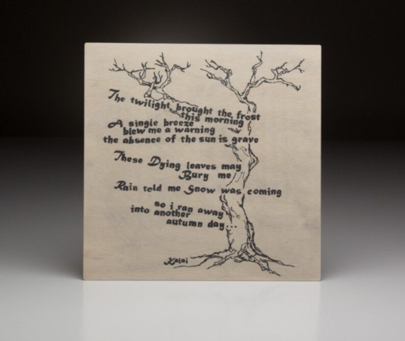 May include: A black and white drawing of a bare tree with a poem about the arrival of frost and snow. The poem reads: "The twilight brought the frost this morning. A single breeze blew me a warning. The absence of the sun is grave. These Dying leaves may Bury me. Rain told me Snow was coming so I ran away into another autumn day..." The poem is signed "Balai".