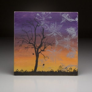 May include: A painting of a bare tree silhouetted against a sunset sky. The sky is painted in shades of purple, orange, and yellow. The tree is black and the background is a gradient of colors.