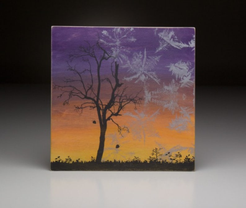 May include: A painting of a bare tree silhouetted against a sunset sky. The sky is painted in shades of purple, orange, and yellow. The tree is black and the background is a gradient of colors.