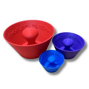 May include: Three brightly coloured, cone-shaped objects with a central knob. The largest is red, labelled "Graceful3D - 76-120mm." The medium one is purple, labelled "Graceful3D - 51-80mm." The smallest is blue, labelled "Graceful3D - 35-55mm."