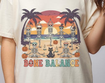 Vintage Spooky Sunset Yoga T-Shirt: Skeletons on Beach, Retro Style