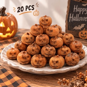 May include: A collection of 20 small, orange, textured pumpkin-shaped ornaments, each featuring a carved jack-o'-lantern face with a sinister grin. The miniature pumpkins are piled together on a white scalloped plate, displaying varied expressions.