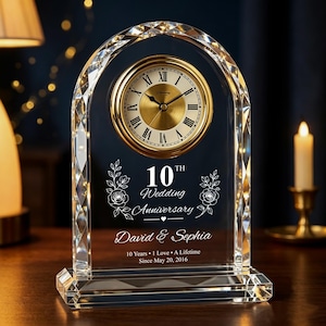 May include: An arched clear crystal mantel clock with a gold-toned circular face featuring Roman numerals. The glass is etched with 10th Wedding Anniversary, the names David & Sephia, and the text 10 Years I Love A Lifetime Since May 20, 2016.